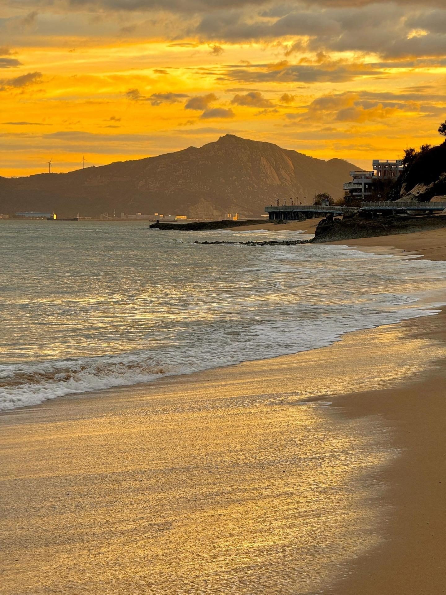 Waves on a sandy beach in Xiamen in late-afternoon light