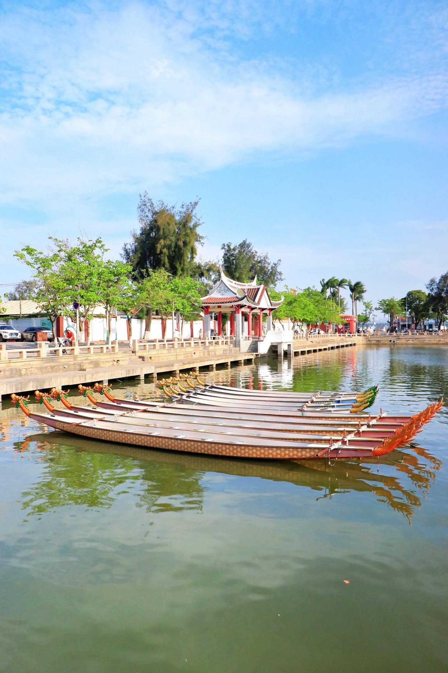 Dragon boats moored beside a pavilion at the Dragon Boat Pond in Jimei